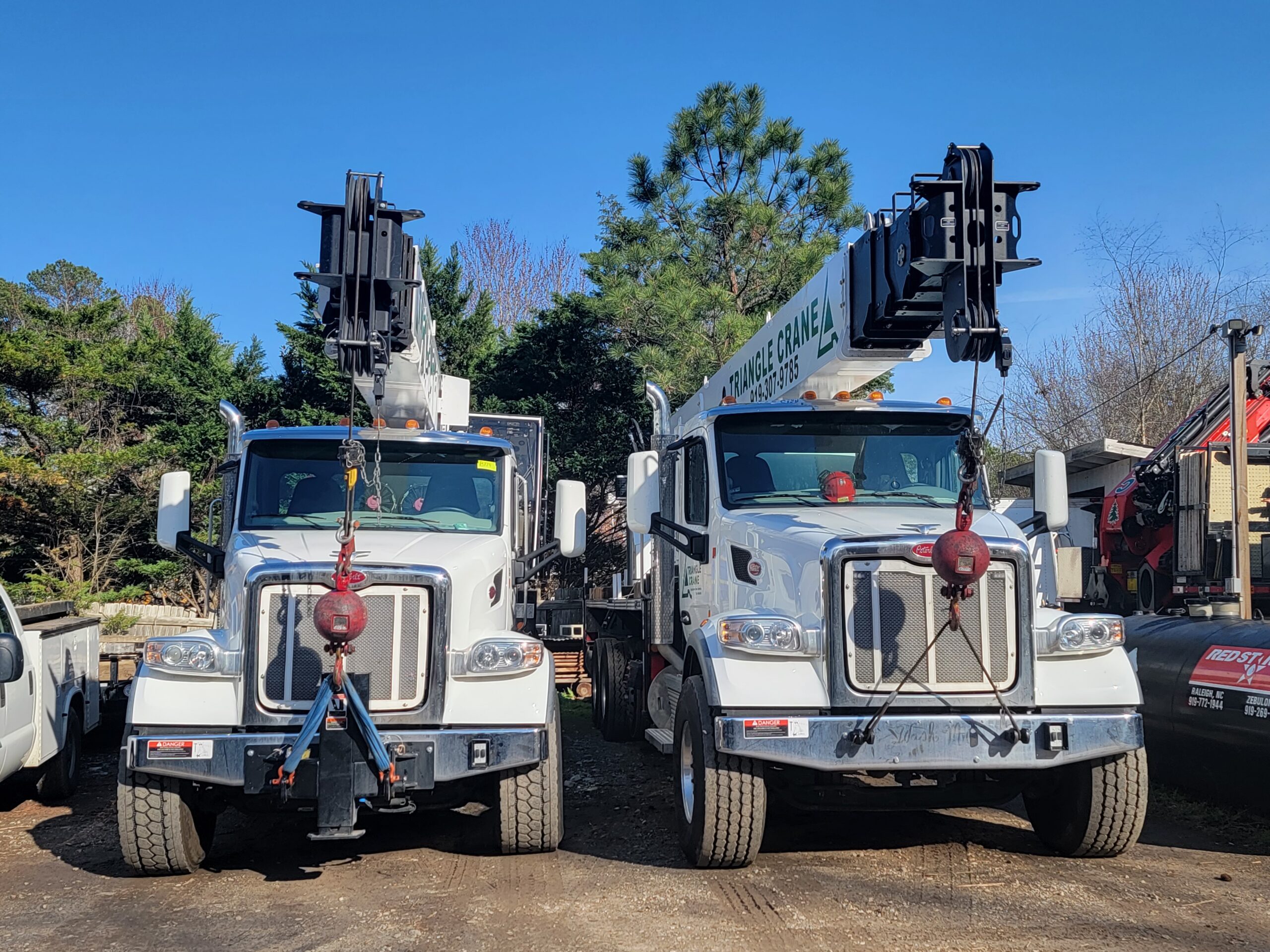 triangle crain white trucks with a crane