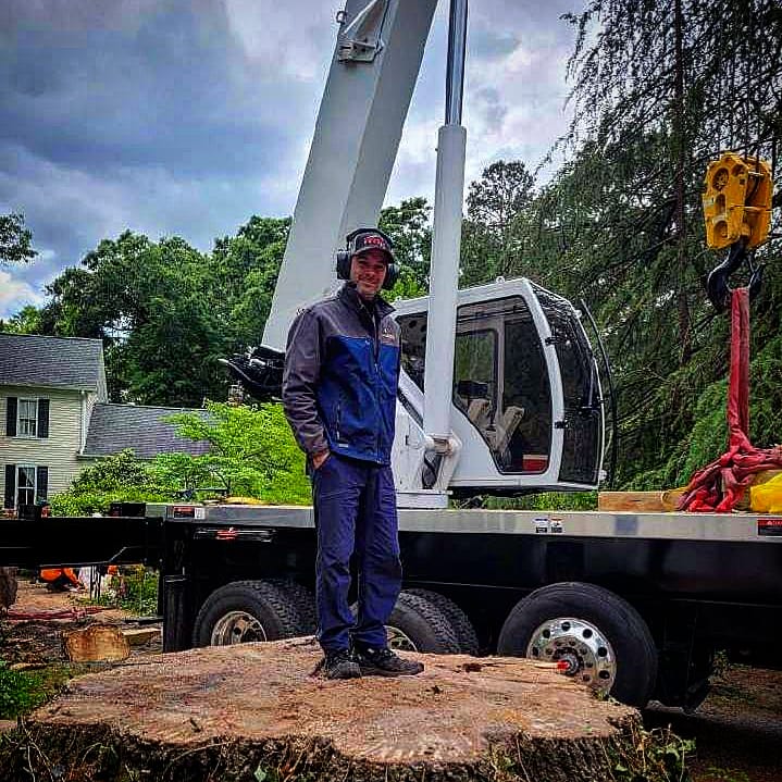 a man in front of a white truck with a crane