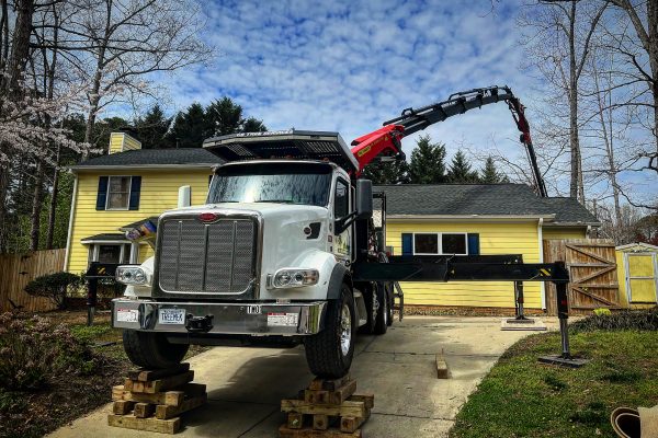 triangle crain white truck with a crane in action