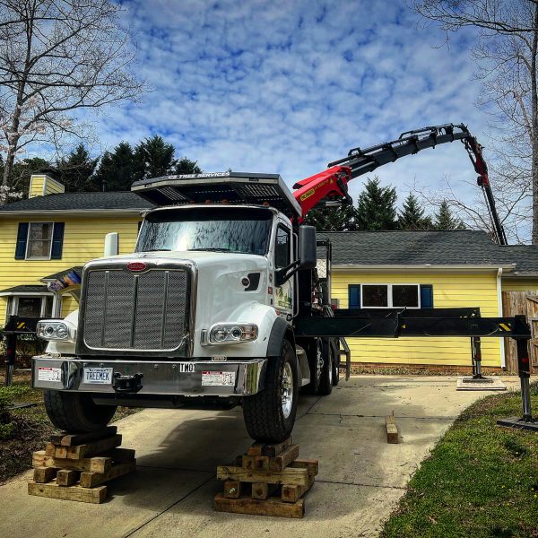 triangle crain white truck with a crane in action